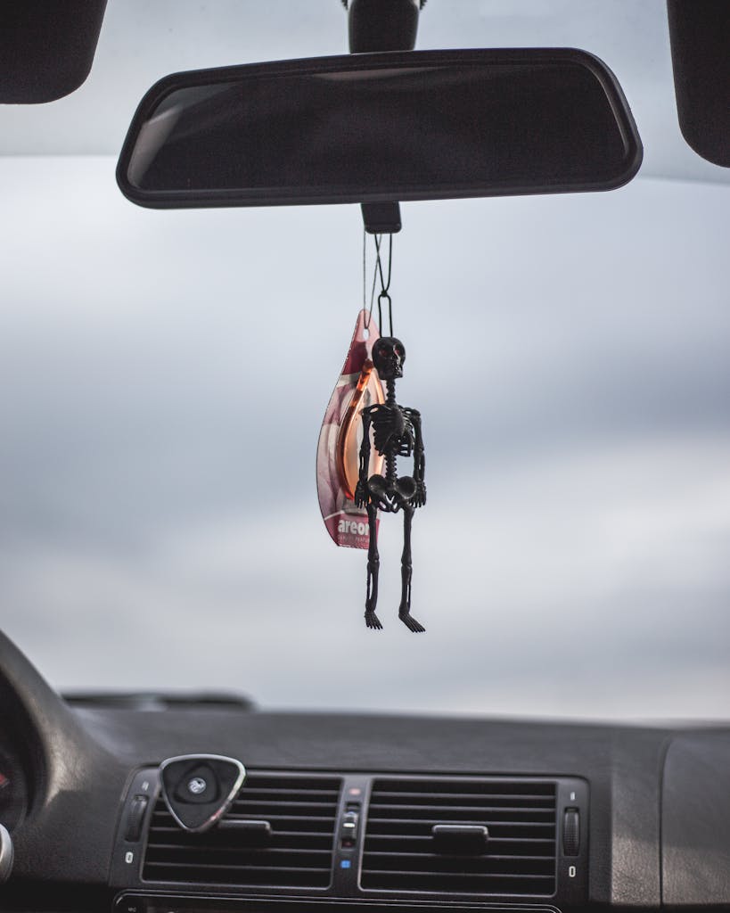 A Skeleton Keychain Inside a Car